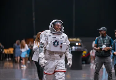 TMRW astronaut mascot walking through the venue