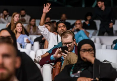 Audience member raising a hand at TMRW Dubai 2023