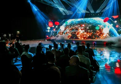 Audience watching a globe projection on the TMRW Dubai 2023 stage